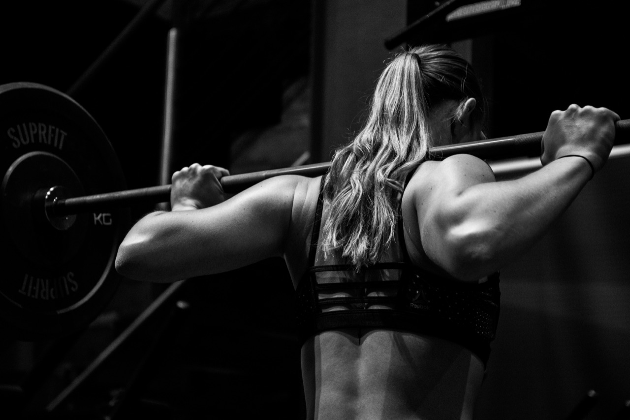An athlete lifting a loaded barbell